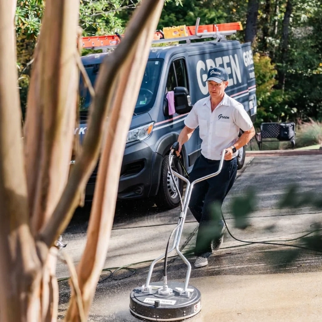 A Green technician cleaning residential windows